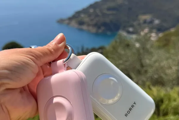 RORRY CharmGo D4 keychain power bank in Rose Quartz pink and Moonstone white, clipped to a bag
